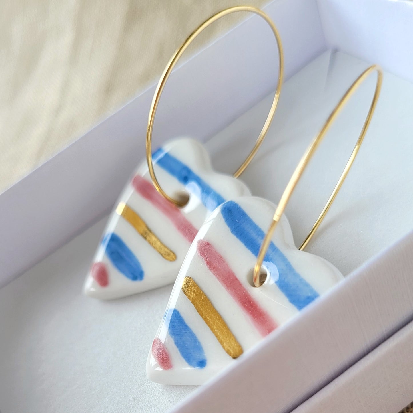 Porcelain dangle earrings with gold "White hearts with stripes"