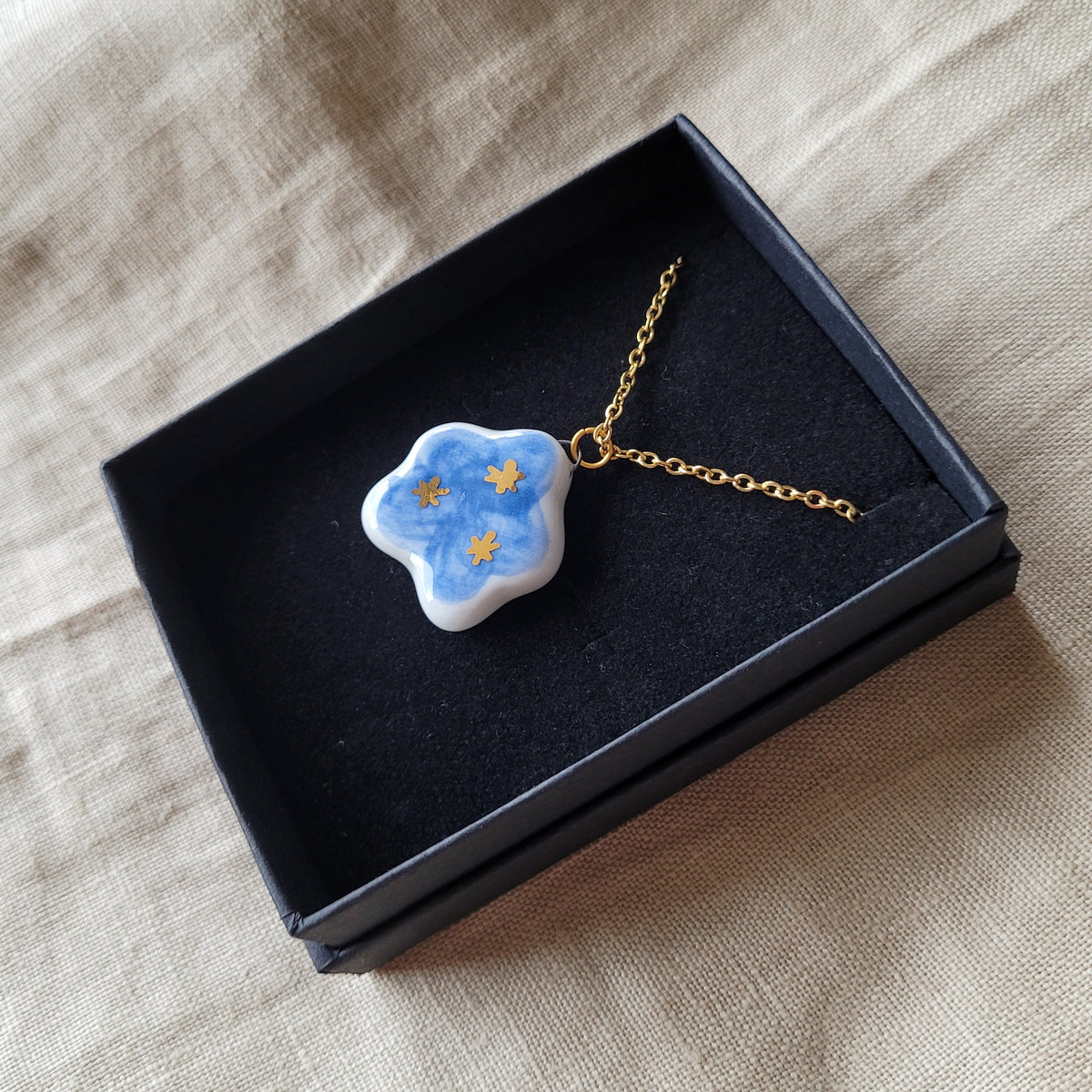 Porcelain necklace with gold "Dark blue cloud with gold stars"