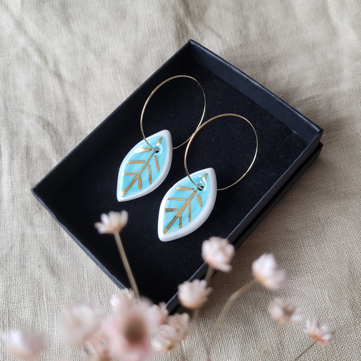 Porcelain dangle earrings with gold "White and light blue leaves"