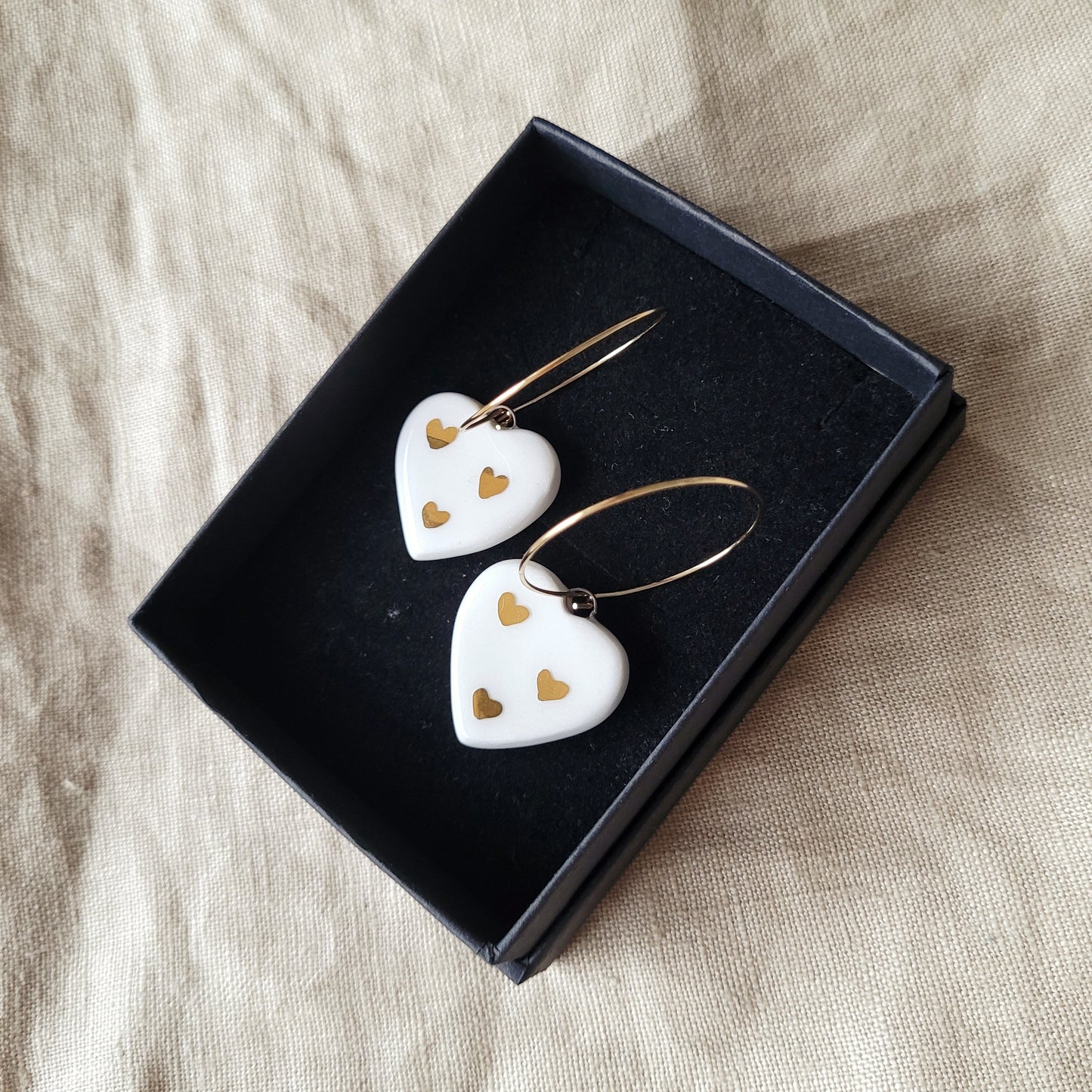 Porcelain dangle earrings with gold "White hearts with little gold hearts"