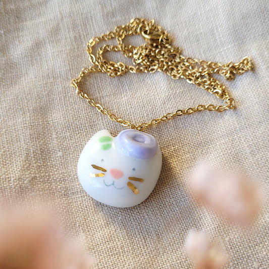 Porcelain necklace with gold "Kitty with light purple flower"