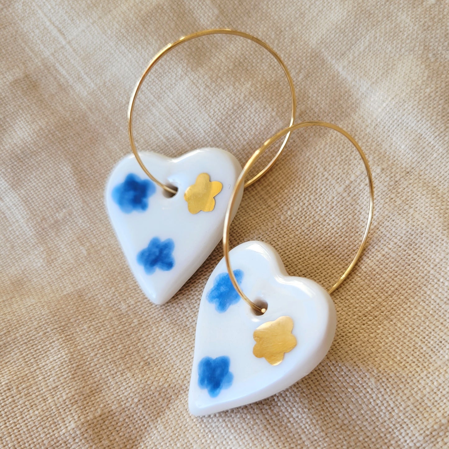 Porcelain dangle earrings with gold "White hearts with dark blue clouds"