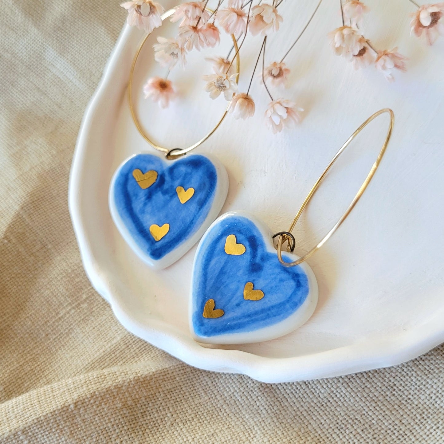 Porcelain dangle earrings with gold "Dark blue hearts"