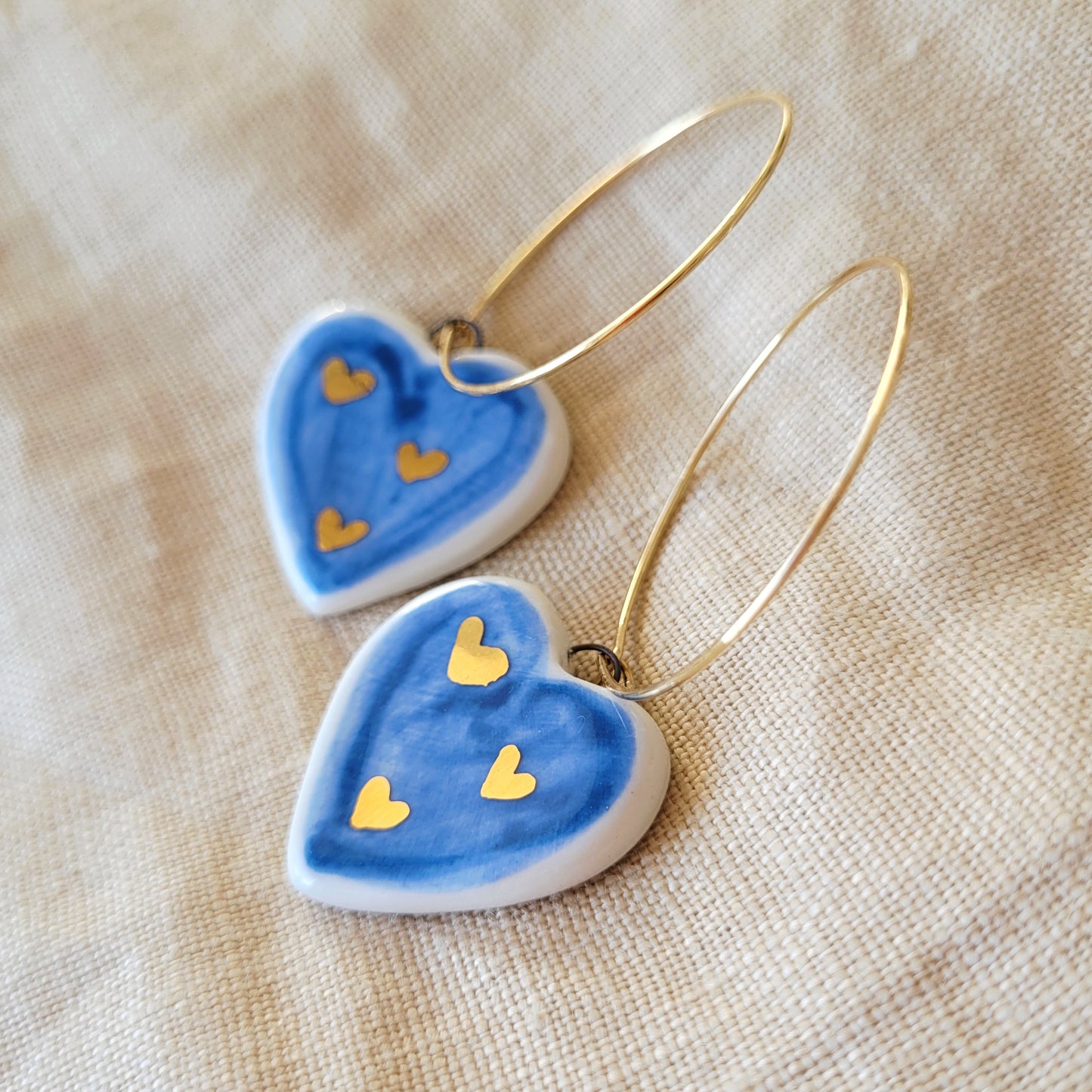 Porcelain dangle earrings with gold "Dark blue hearts"