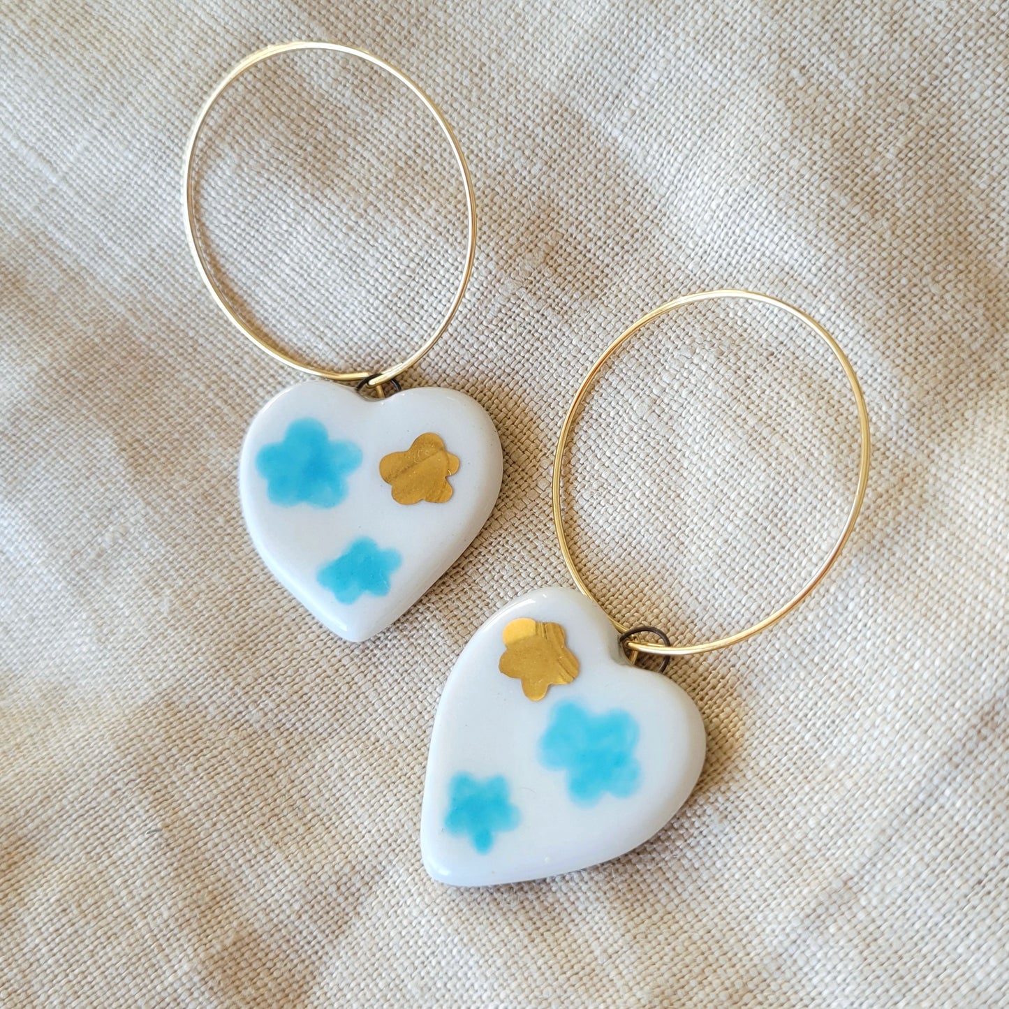 Porcelain dangle earrings with gold "White hearts with light blue clouds"