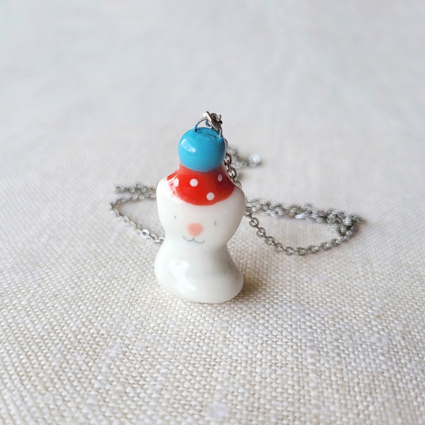 Porcelain necklace "Small party kitty with red hat"