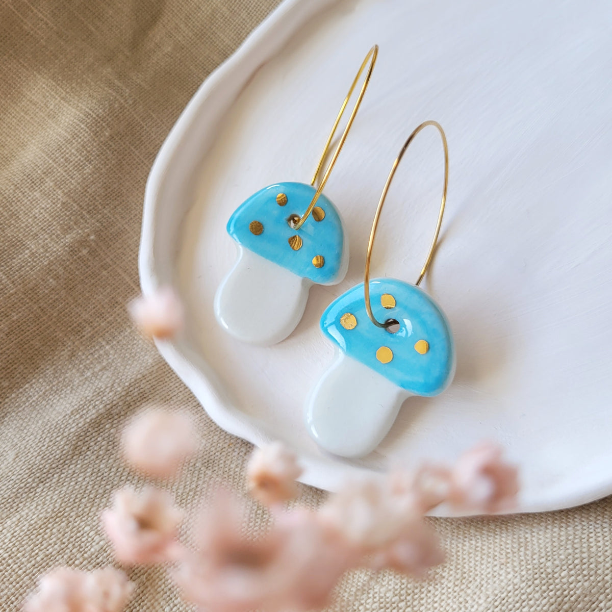 Porcelain dangle earrings with gold "Light blue mushrooms"