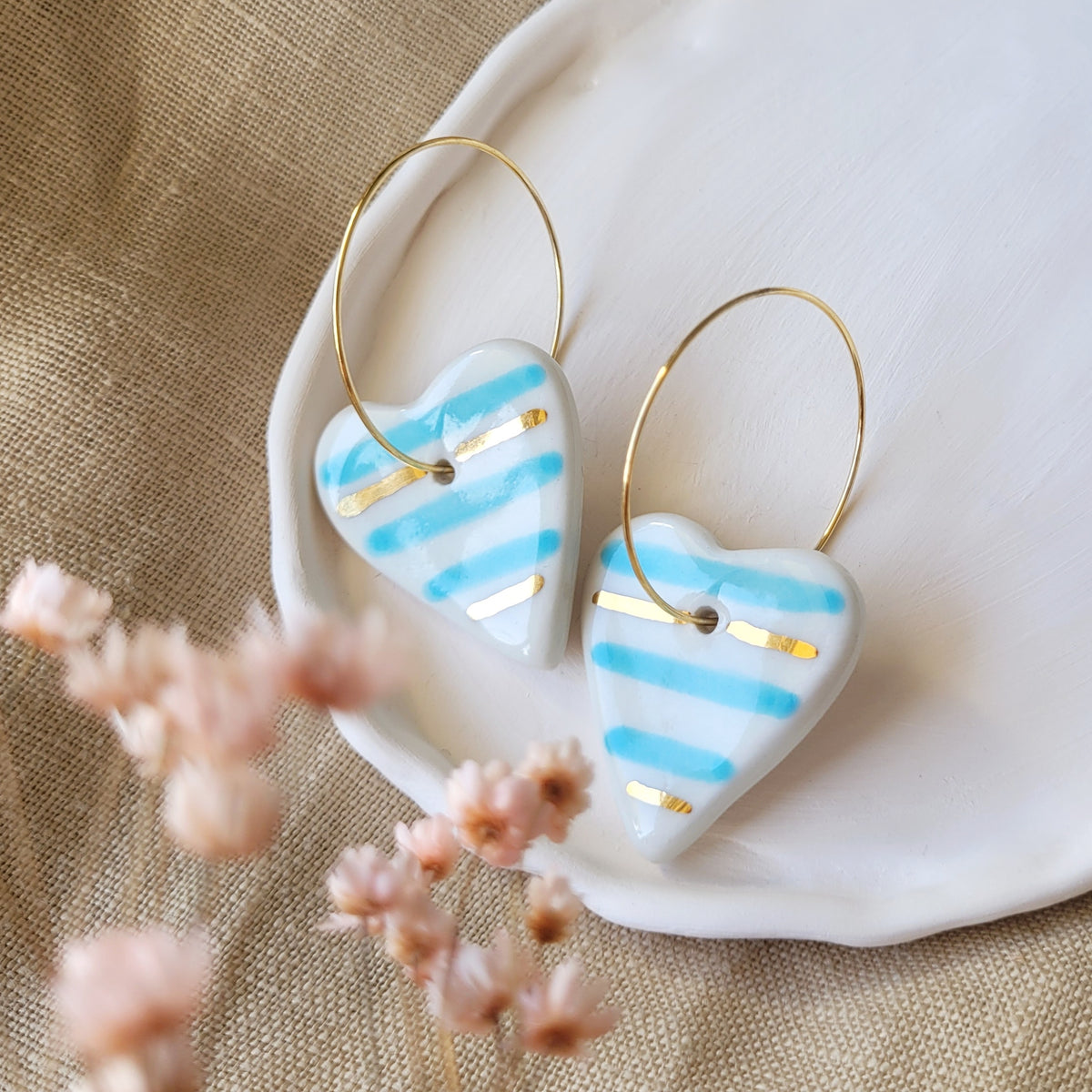 Porcelain dangle earrings with gold "White hearts with blue and gold stripes"