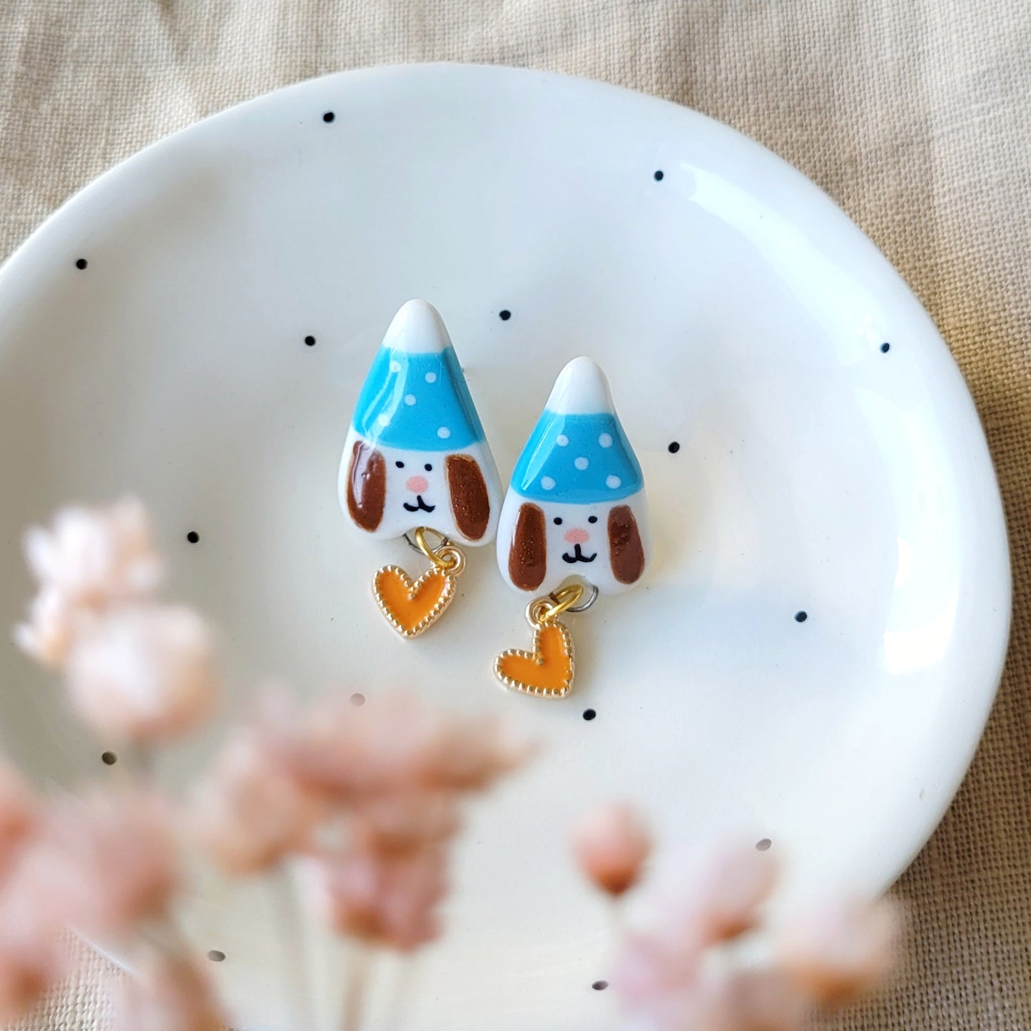 Porcelain stud earrings "Puppies with blue hats and orange hearts"