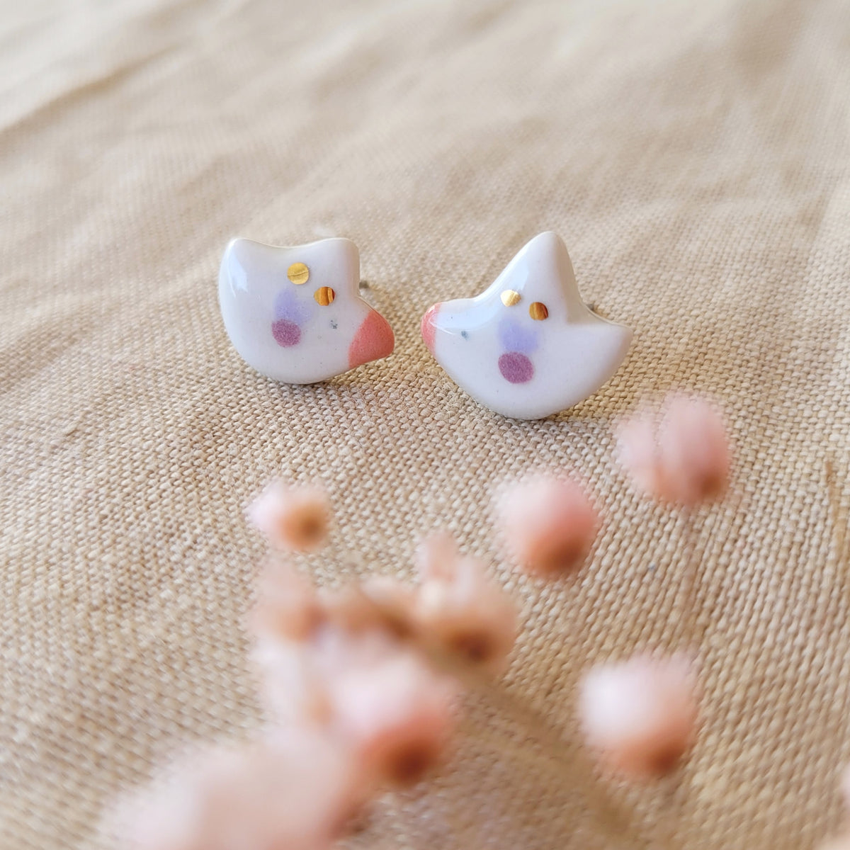 Porcelain stud earrings with gold "Tiny birds with purple and pink wings"