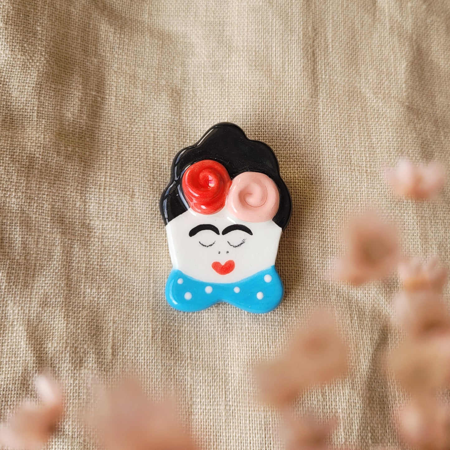 Ceramic brooch "Girl with blue collar and flowers"