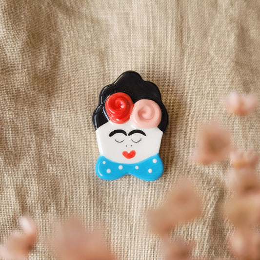 Ceramic brooch "Girl with blue collar and flowers"