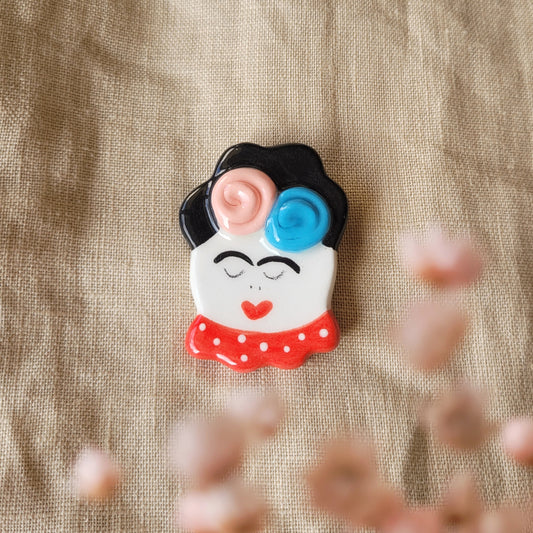 Ceramic brooch "Girl with pink and blue flowers"