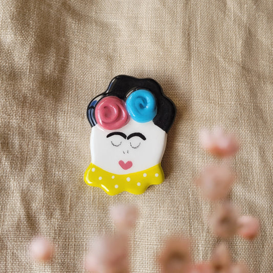 Ceramic brooch "Girl with dark pink and blue flowers"