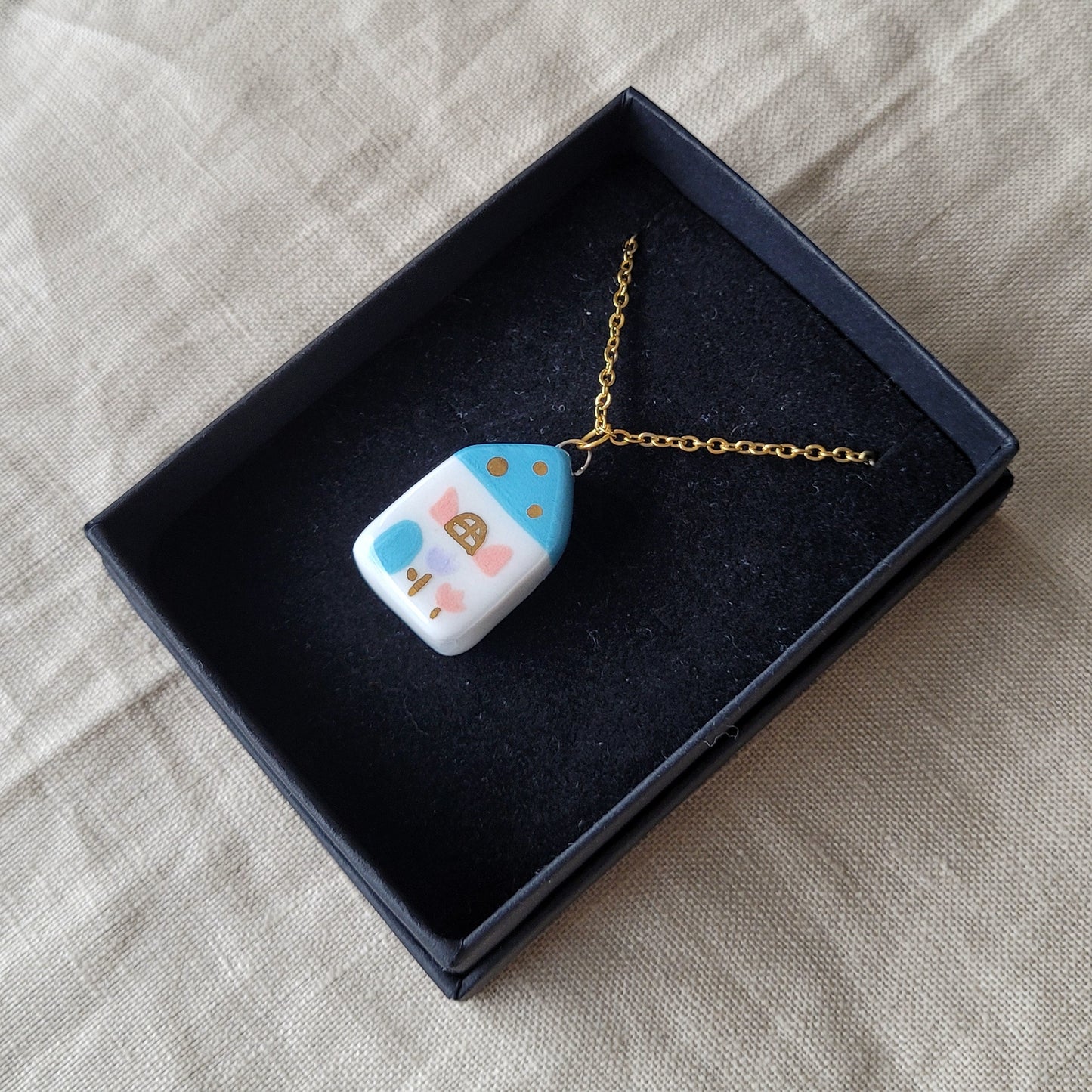 Porcelain necklace with gold "Blue house with pink window"