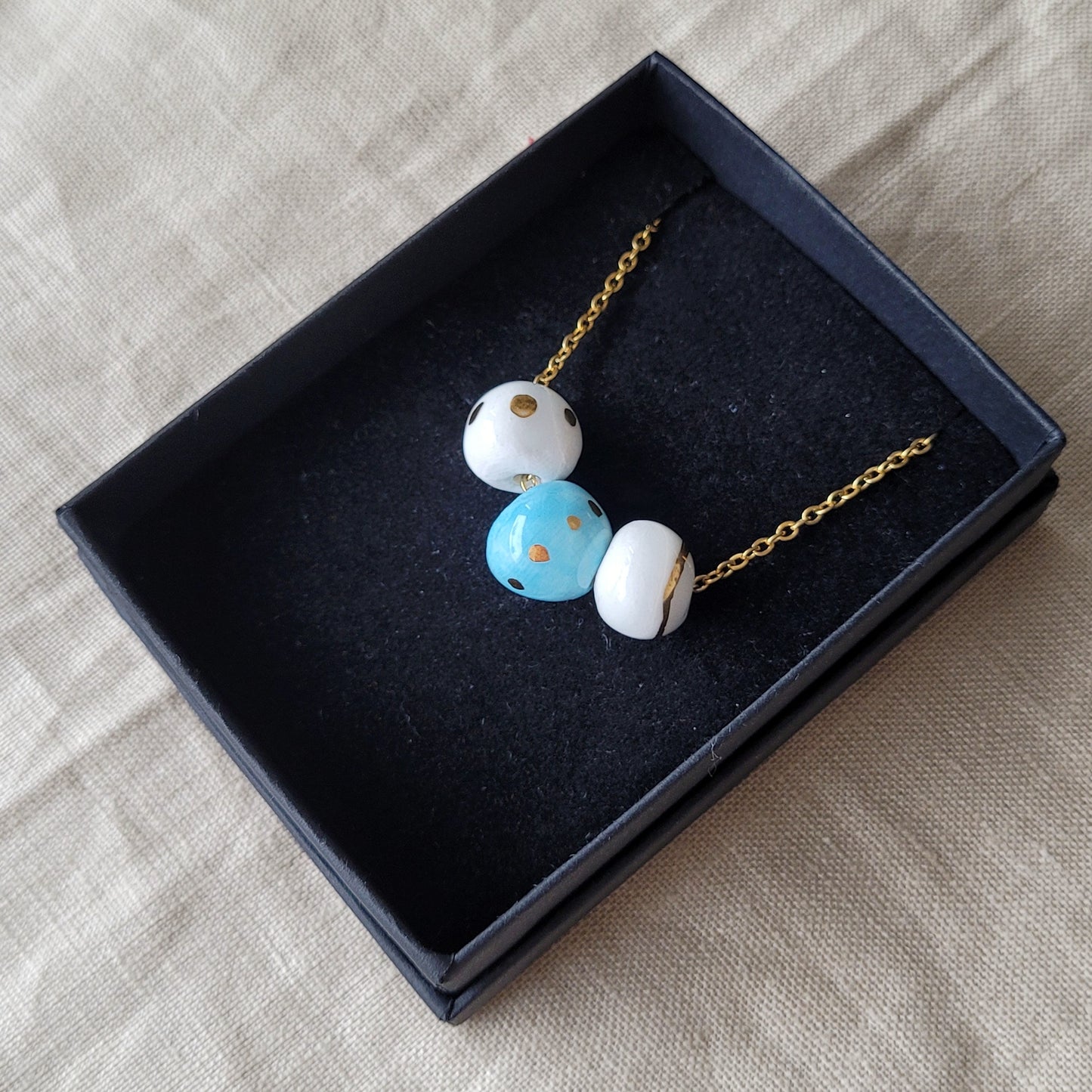 Porcelain necklace with gold "White, gold and blue"