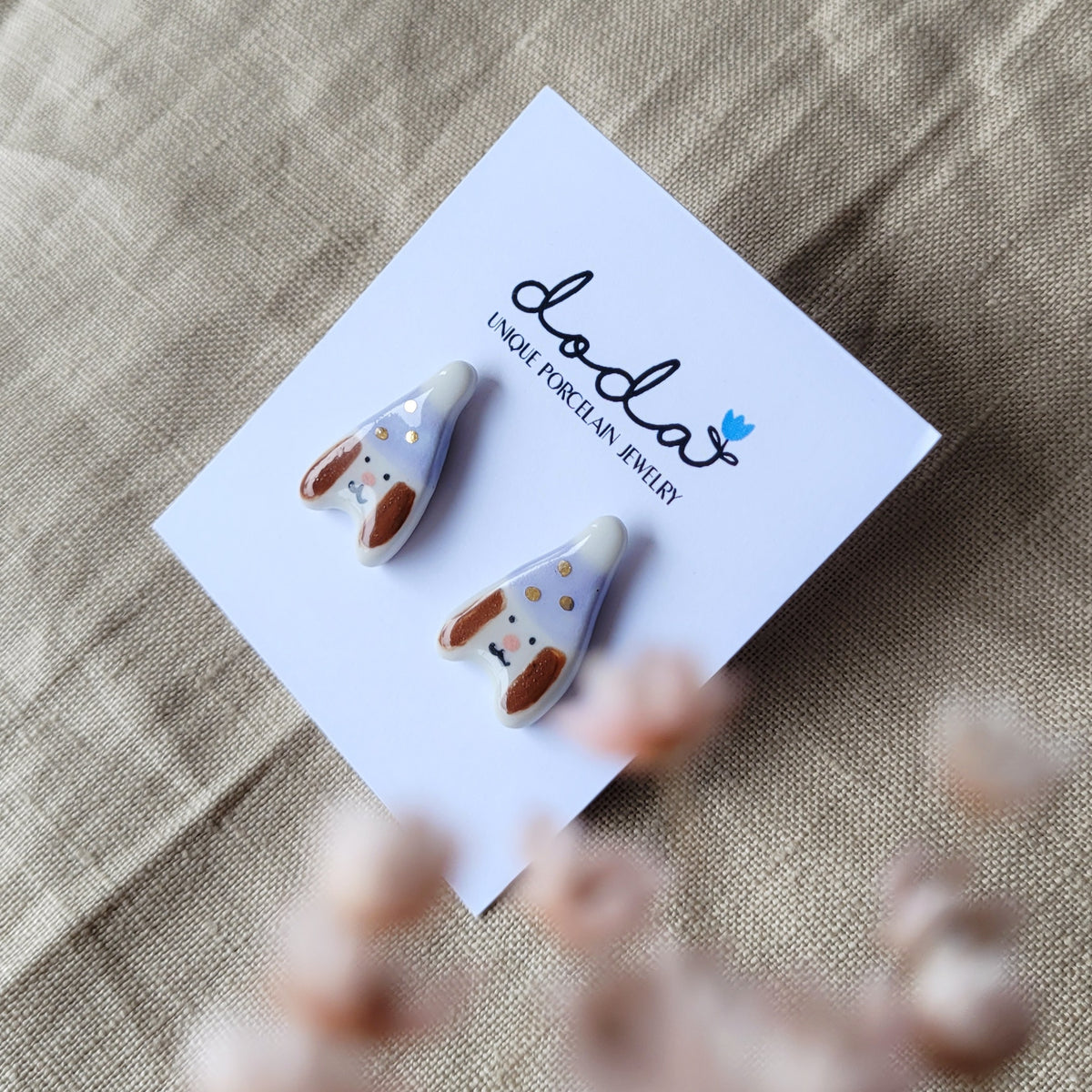 Porcelain stud earrings with gold "Puppies with light purple hats"