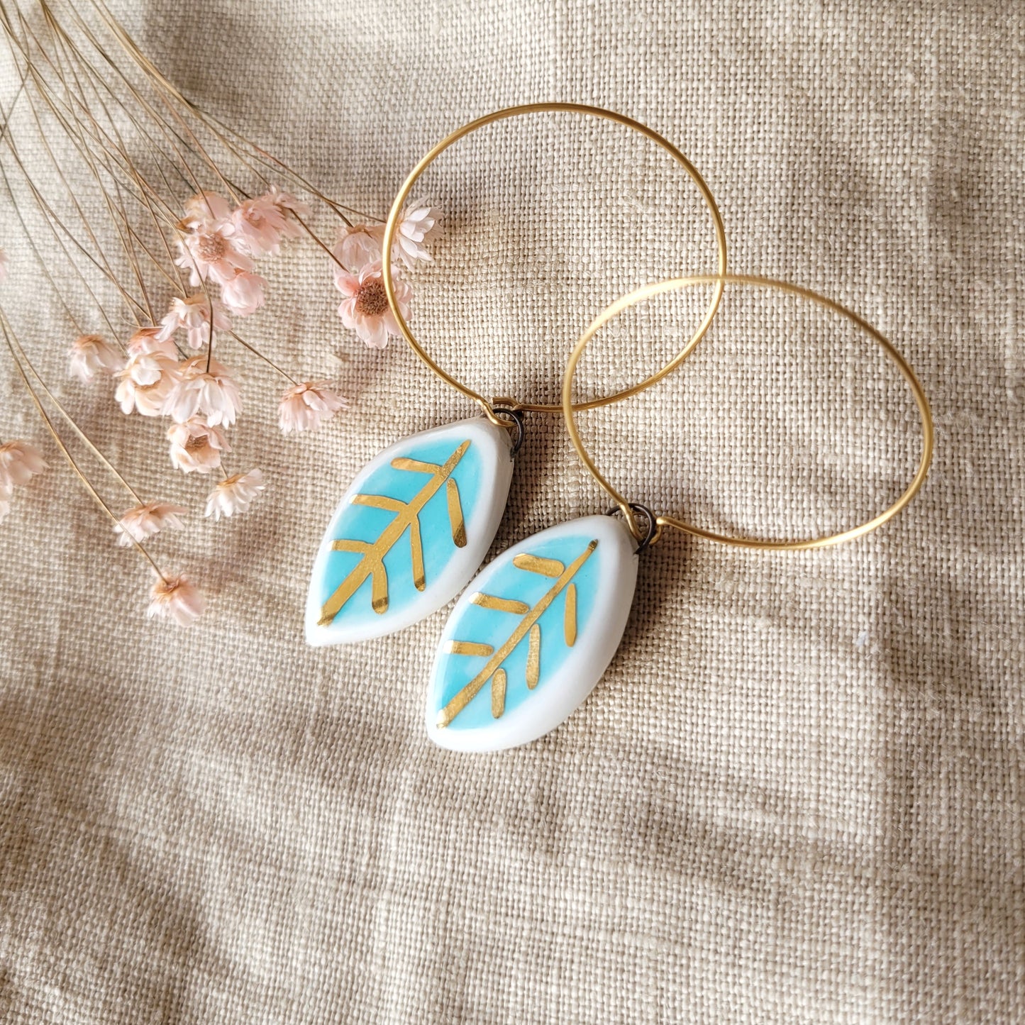 Porcelain dangle earrings with gold "Small white and light blue leaves"