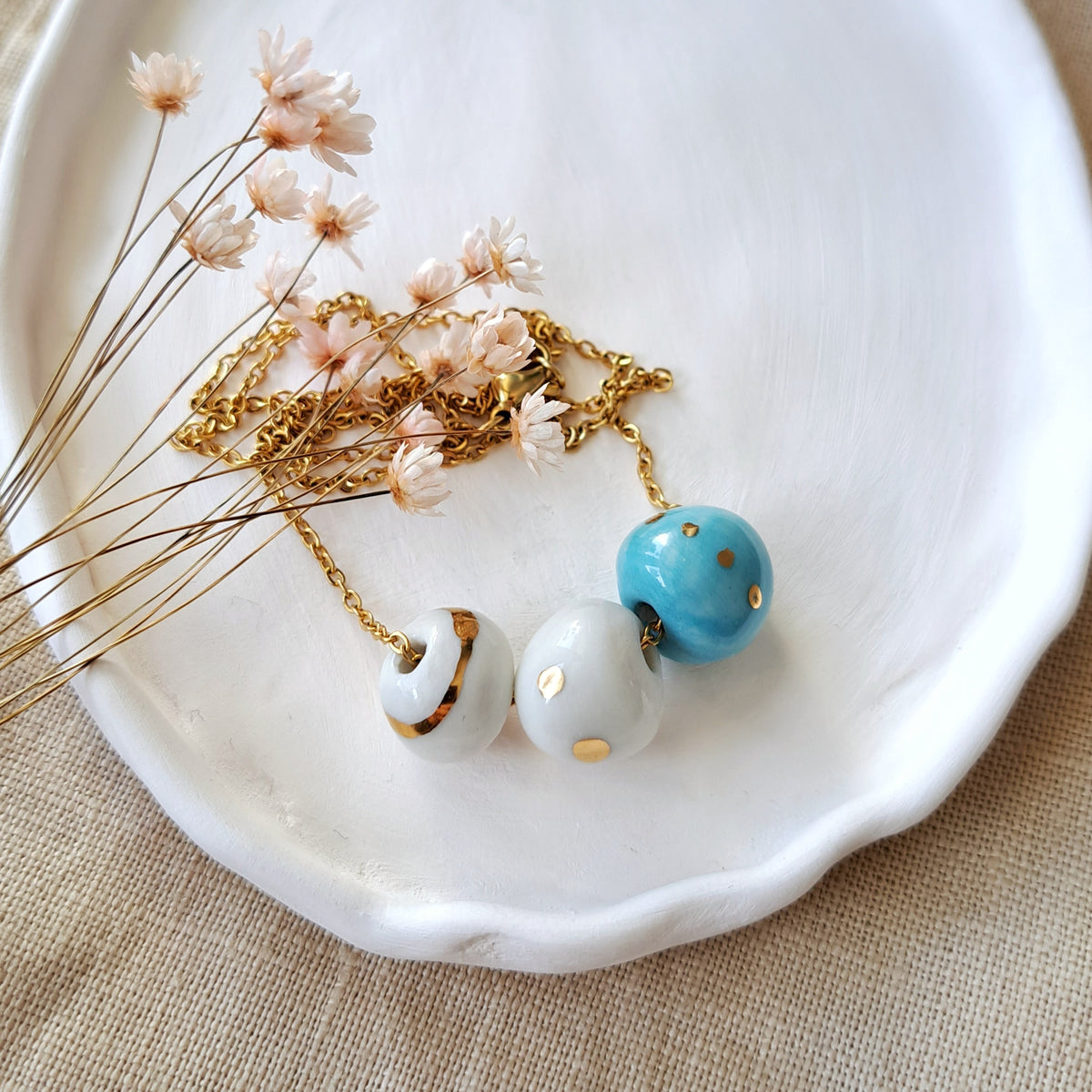 Porcelain necklace with gold "White, blue and gold"