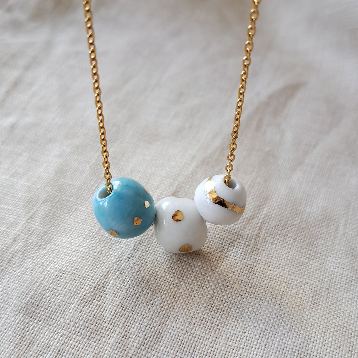 Porcelain necklace with gold "White, blue and gold"