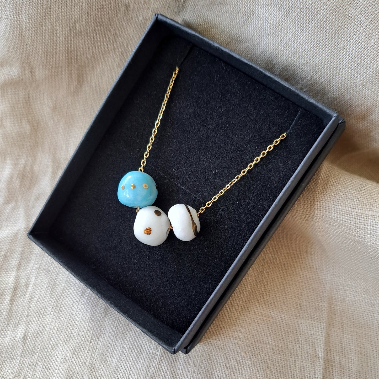 Porcelain necklace with gold "White, blue and gold"