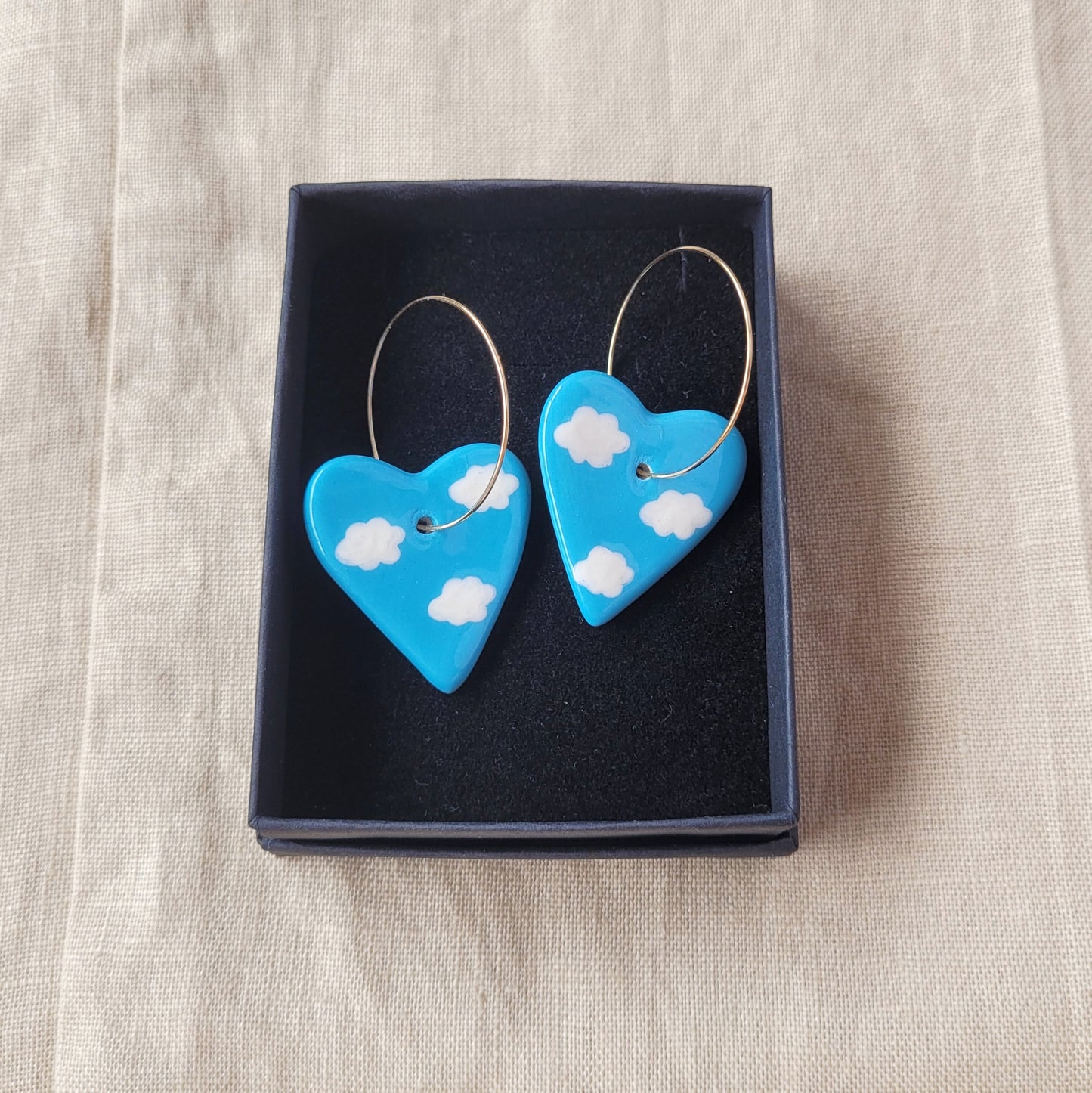 Ceramic dangle earrings "Blue hearts with white clouds"