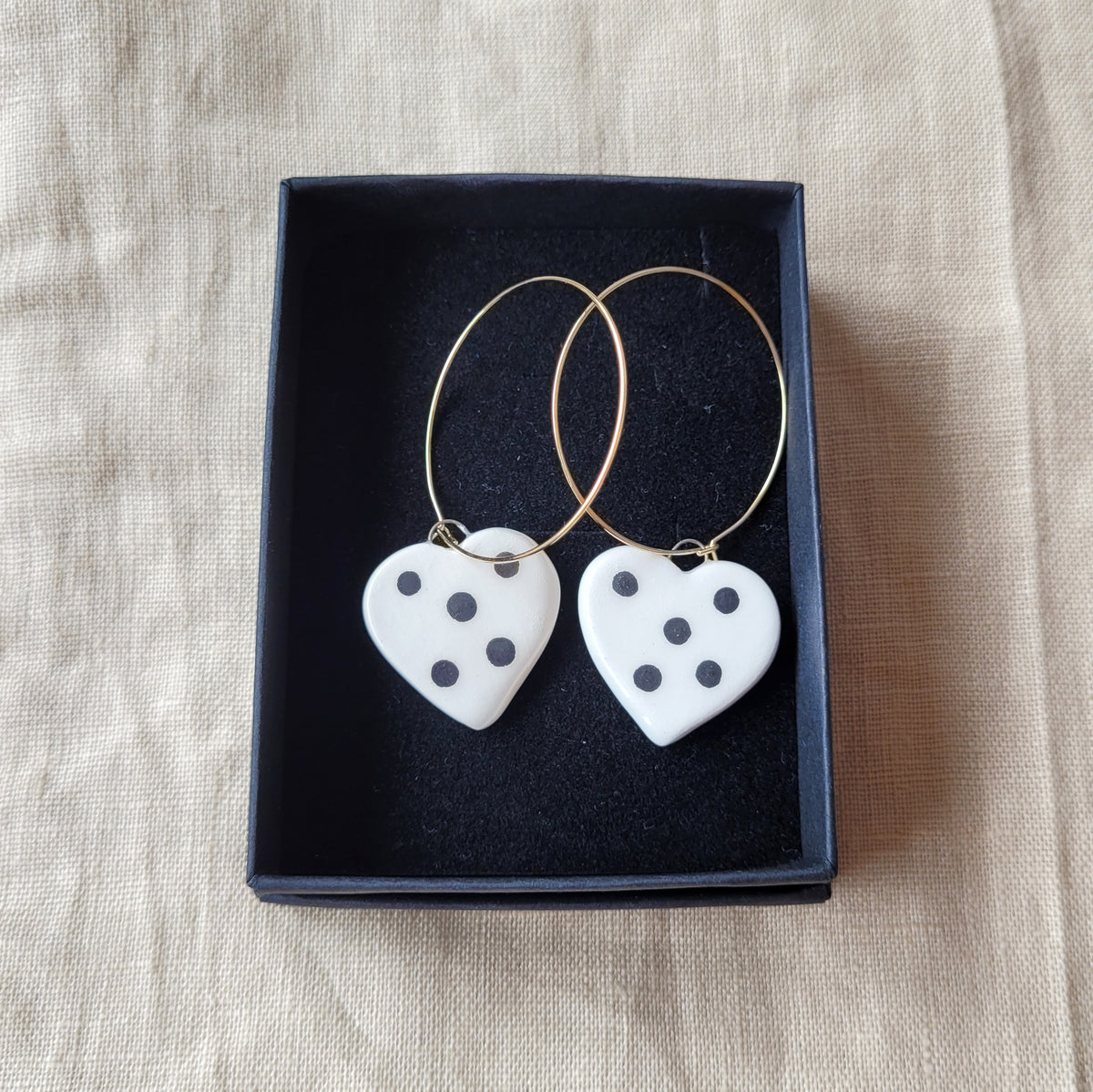 Ceramic dangle earrings "Small white hearts with big black dots"